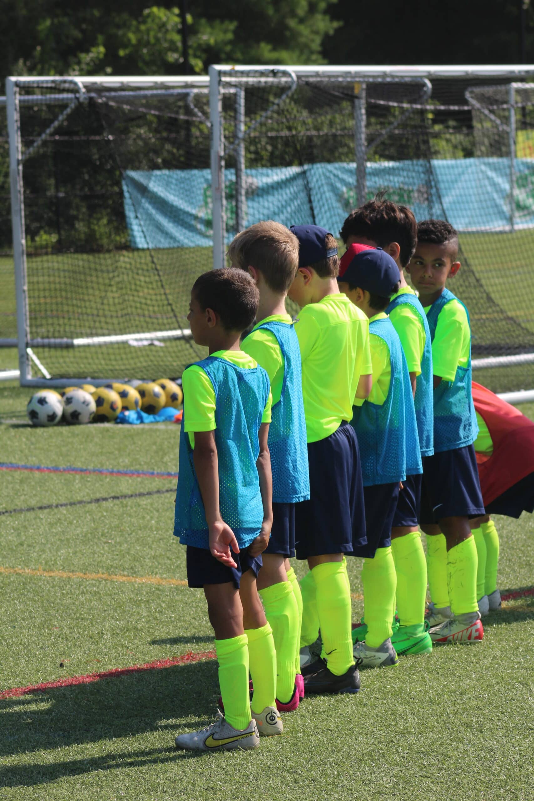 How to recover after a soccer game: kids getting ready to stretch.