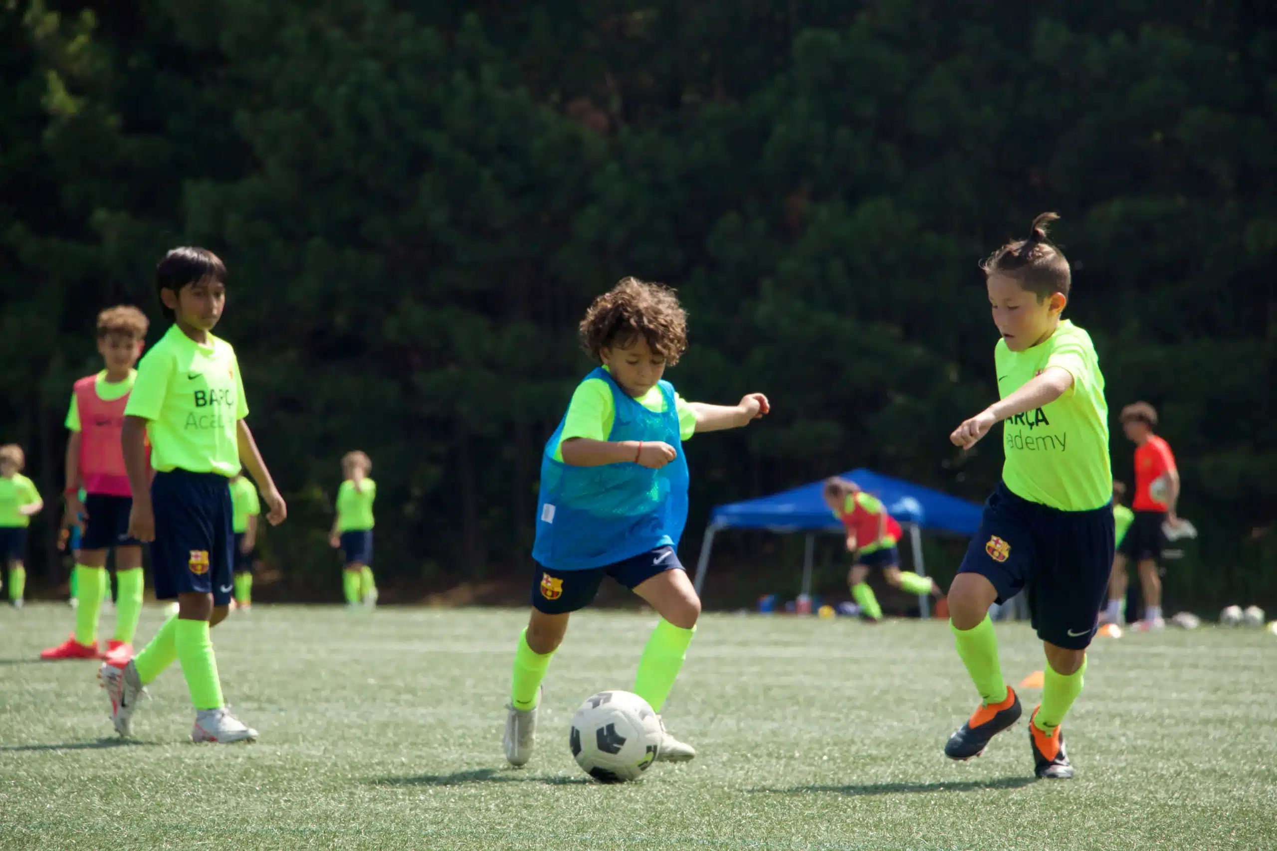 Three kids training in a premier soccer academy